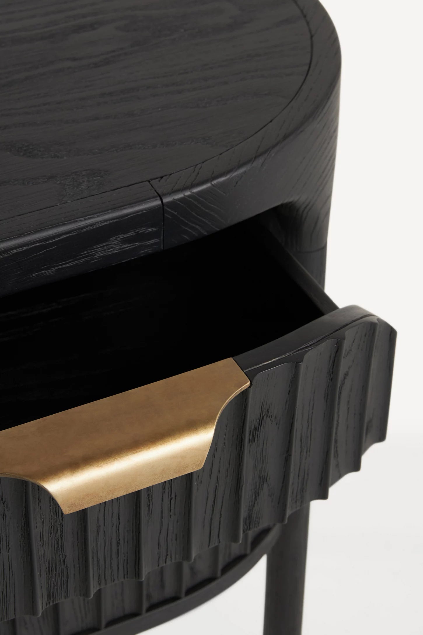 Black side table with a gold handle on a white background